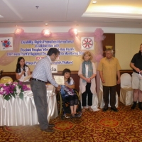 Roosevelt Benjamin holds his certificate in front of facilitators.