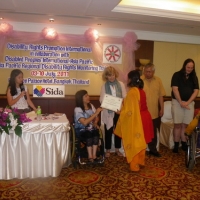 Farhana Mustary of Bangladesh receives her certificate from Saowalak and is congratulated by Marcia Rioux. 