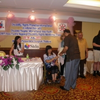 Birendra Raj Pokharel holds his certificate with Saowalak Thonkuay while other facilitators look on. 