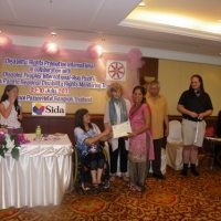 Ram Pyari Karki holds her certificate with Saowalak Thonkuay while other facilitators look on. 