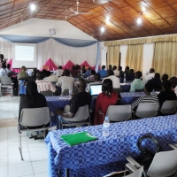 <p>
	Mr. Oswald BURASANZWE is at the front of a lecture room, facing a screen showing a powerpoint presentation on the Prime Minister&#39;s Order determining the responsibilities, organization and functioning of the Organs of the National Council of persons with disabilities in Rwanda. Participants are sitting in rows of tables, facing the presenter.</p>
