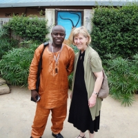 <p>
	Professor Marcia Rioux and Oswald Tuyizere taking a photo on the wall of the hotel hosted the meeting.</p>
