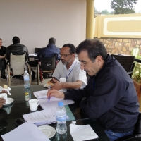 Mohamed El Khadiry and Moosa Salie work at a table covered training materials.