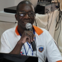 Robert Mkozho speaks into a microphone.