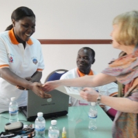 Prof. Marcia shakes hands with Esther Kyozira while giver her a certificate
