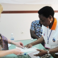 Magdalena Tiba Kaihuzi is handed a certificate by Marcia Rioux
