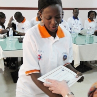 Gloria Namureme is handed a certificate by Marcia Rioux