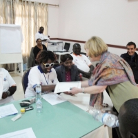 Roseweter Mudarikwa smiles while Marcia Rioux gives her a certificate.