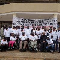 All the participants and facilitators of the training workshop pose together for a big group shot in front of the entrance of the hotel.