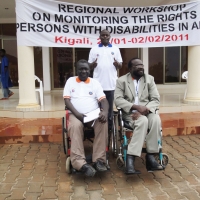 <p>
	Mohamed Fall (left), Tambo Camara (right) and Oswald Tuyizere (behind) pose for a photo outside the hotel entrance</p>

