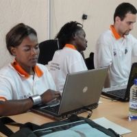 Bongi Malope, Mercy Murgure and Chris Lytle work on laptops.