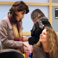 Miha Dinca (standing) is conversing with Dr. Roxanne Mykitiuk (sitting)