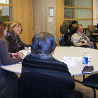 Sandra Carpenter, Dr. Marcia Rioux and Dr. Roxanne Mykitiuk are sitting at a tab