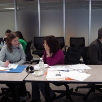 <p>
	Two delegates sit side by side at the meeting table, as they discuss monitoring.</p>
