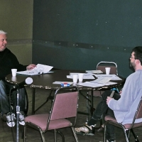 <p>
	Normand Boucher speaks with Lyne Robichaud and Jean-Michel Bernier as they sit around a table littered with training materials and styrofoam cups.</p>
