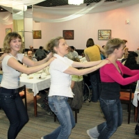 <p>
	Five participants hold on to one another and dance in single file.</p>
