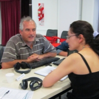 <p>
	Naziberto Oliveira, Camila Albin and Andrea Cortes during interview practice. All three participants are seated at a table facing each other.</p>

