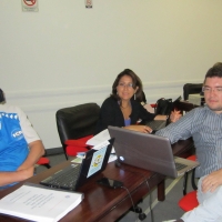 <p>
	Domingos Montagna, Ana Lucia Arellano and Alexandre Mapurunga sit at a table with their computers open and their head phones on.</p>
