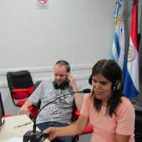 <p>
	Marcela Omedo at a table, speaking to the larger group during the training; German Sciurano is on her left.</p>
