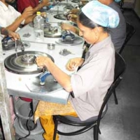 <p>A woman working among others at her workstation at Rajiv Gems Park</p>
