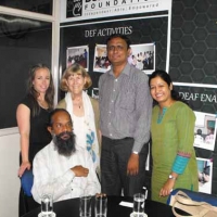 <p>Alexis Buettgen and Marcia Rioux pose with representatives of the Deaf Enabled Foundation and Pavan Muntha.</p>
