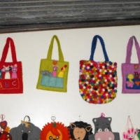 <p>Colourful purses hanging on a wall</p>
