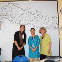 <p>Paula Hearn, a staff person from Handicap International, Nepal and Marcia Rioux &nbsp;posing in front of a whiteboard with a &nbsp;map.</p>
