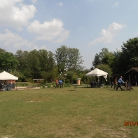 In the back garden there are people assisting guests in wheelchairs.