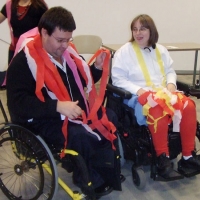 Two participants covered in streamers at the end of the training, both are smiling. 