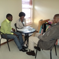 <p>
	Jabulane Dikgale, Tshepo Thibela and Ethel Dibakoane sit in a room near the training venue.</p>
