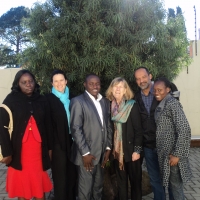 Roseweter Mudarikwa, Rita Samson, Oswald Tuyizere, Marcia Rioux, Moosa Salie and Mercy Gichunge are posing a group photo behing the training venue.