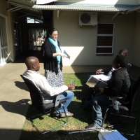 <p>
	Surprise Mugope, Tshepo Thibela and Sipho Mashego are are sitting outside of the training venue while Rita Samson looks on.</p>
