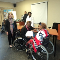 Puleng Moalusi is receiving certificate from Bongiwe Malope who is smiling.