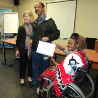 Moosa Salie is receiving a certificate from Bongiwe Malope, while Marcia Rioux is standing next to them. 