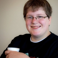 Deborah Gilbert smiling while holding a styrofoam cup.