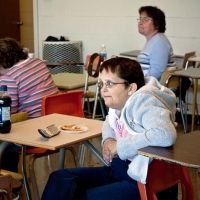 Lynn Seaward is sitting at a desk.