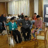 Desa Peruničić, Mersad Muric and Sonja Smajic all listen to translation after an evening activity. 