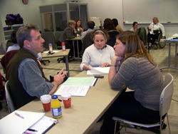 Jen, Melanie and Matthew sitting at a table and talking.