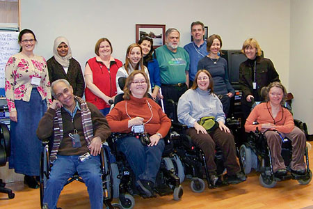 Training participants smile as they pose for a group photo