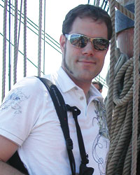 A photo of Jon smiling while aboard a tallship.