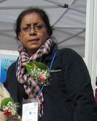 A picture of Kuhu Das with a flower on her lapel