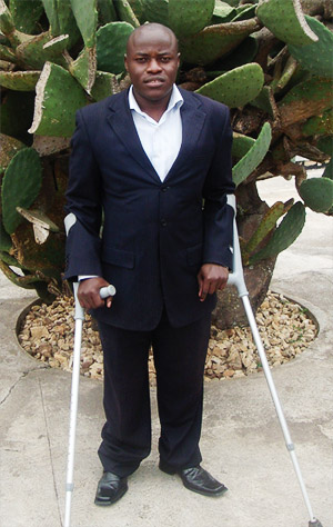 Mr. Oswald TUYIZERE stands in front of a cactus